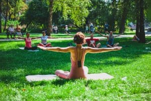 Yoga instructor leading a class in a park